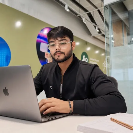 Anmol Garg working at his laptop